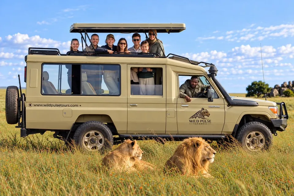 Guests watching lions beside a Wild Pulse safari vehicle